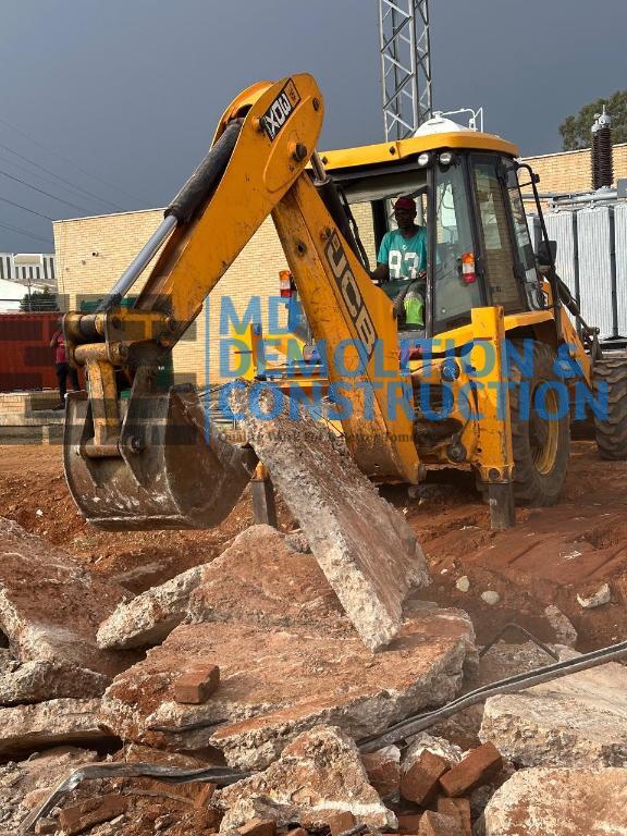TLB performing residential demolition in Sandton, Johannesburg by MD Demolition And Construction.